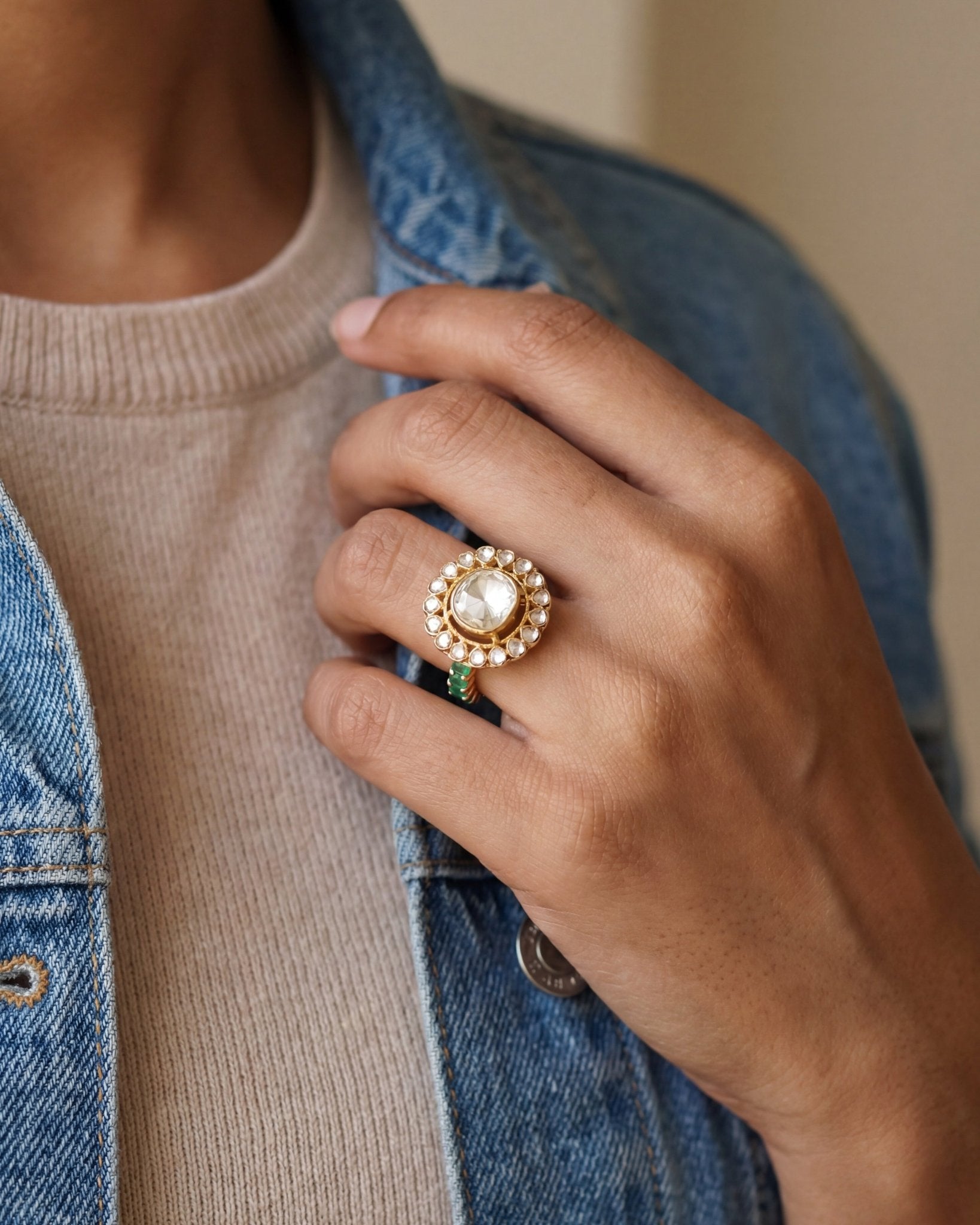 Sunburst Polki Ring in 14K gold with a central Polki halo of Zambian emeralds.