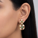 18K gold earrings with a central Polki diamond surrounded by vibrant emeralds.