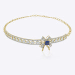 The Bowline Choker in 14K gold with a bow motif, blue stone, Polki, and diamonds.