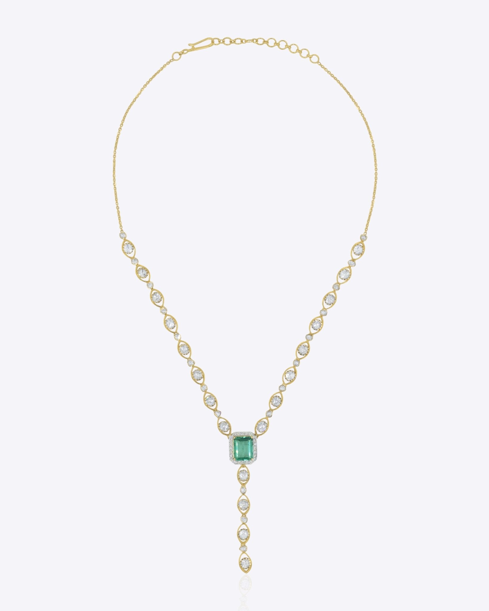 14K gold Oculis necklace with a central green stone and stacked Polki.