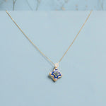 9kt gold pendant with deep blue enamel in a delicate charm shape