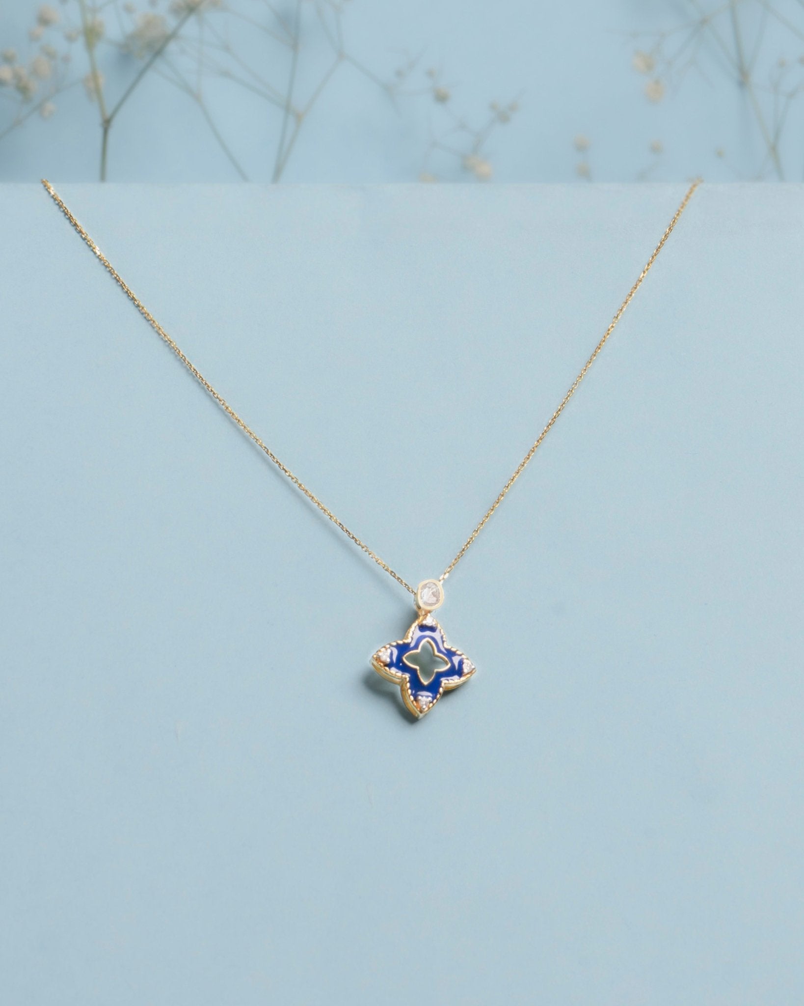 9kt gold pendant with deep blue enamel in a delicate charm shape