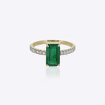 14K gold ring with an emerald-cut emerald and a diamond-accented shank.
