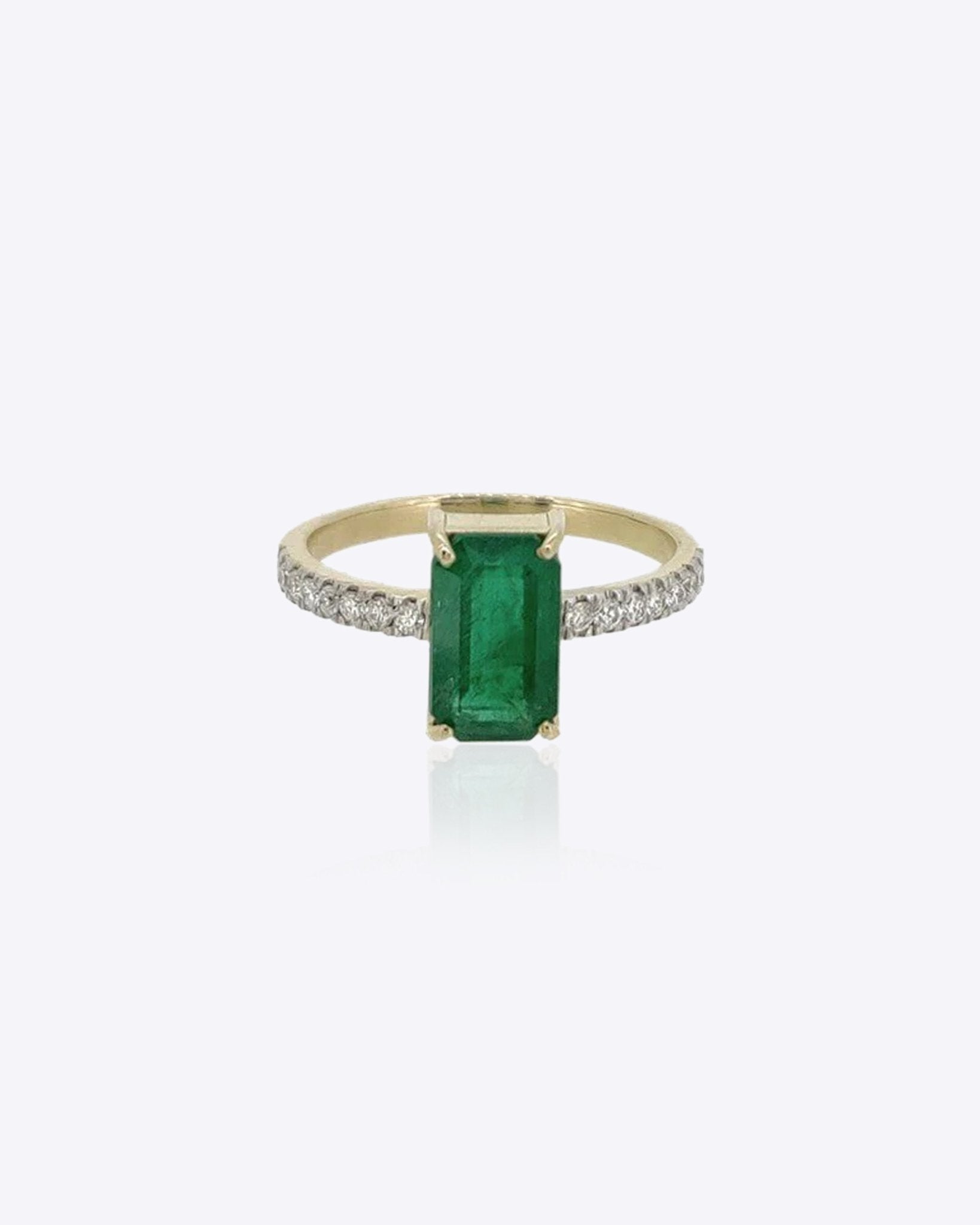 14K gold ring with an emerald-cut emerald and a diamond-accented shank.