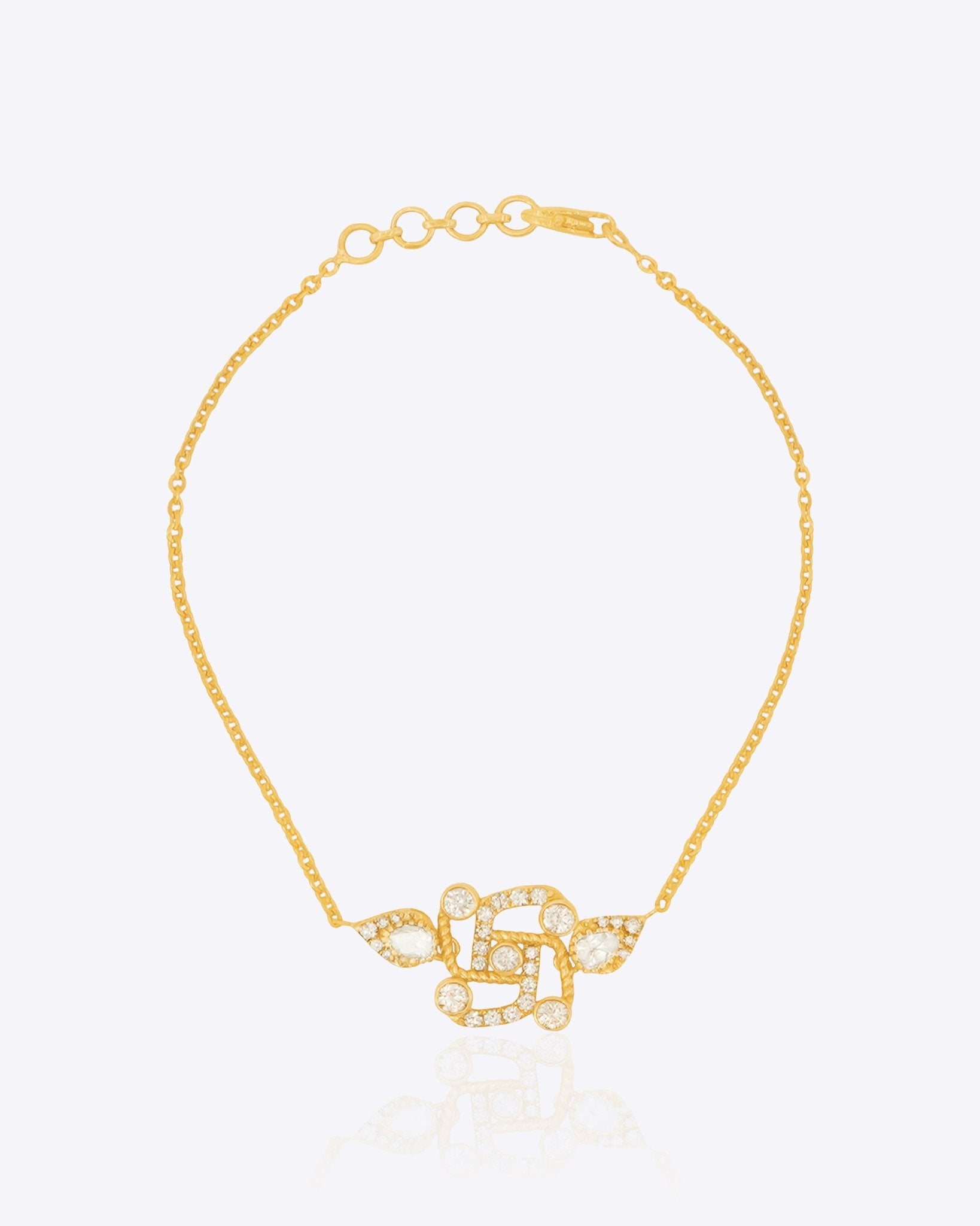Swastik Sutra Bracelet in 14K gold with a Polki and diamond-outlined Swastik motif.