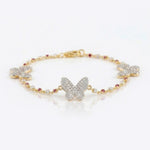 14k gold bracelet with diamond butterfly motifs and pink Rhodochrosite accents