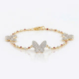 14k gold bracelet with diamond butterfly motifs and pink Rhodochrosite accents