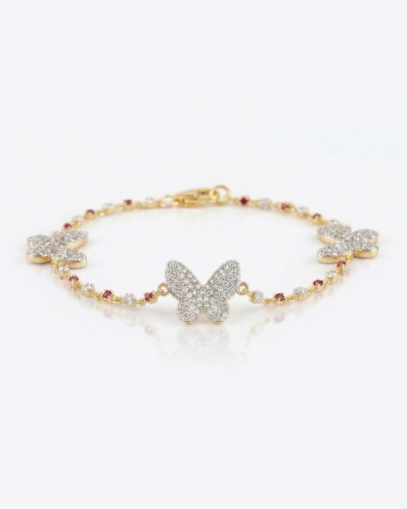 14k gold bracelet with diamond butterfly motifs and pink Rhodochrosite accents