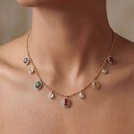 18K gold necklace with a graceful rhythmic design and a soft rosy tone.