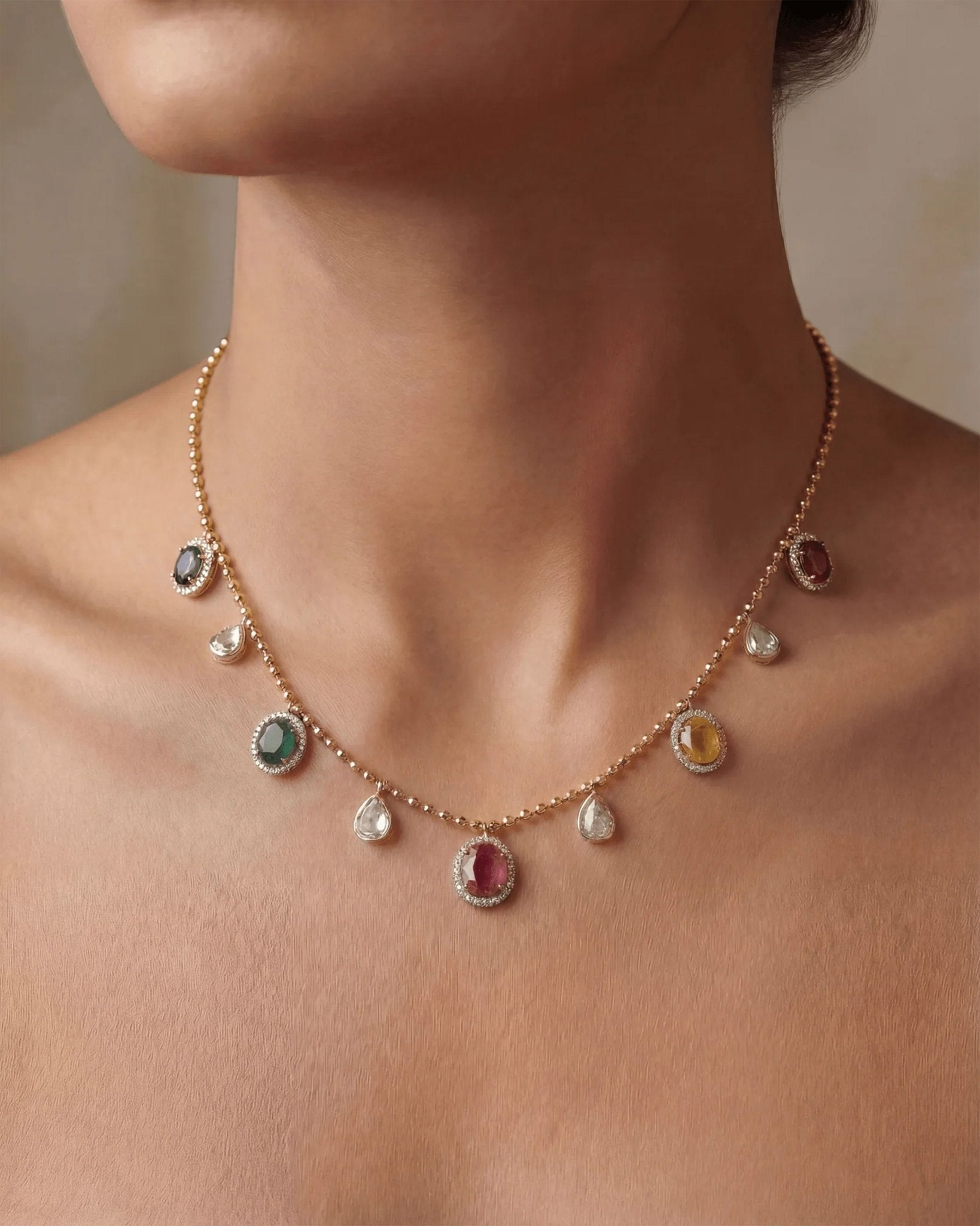 18K gold necklace with a graceful rhythmic design and a soft rosy tone.