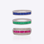 18K white gold stackable ring trio with vivid blue, crimson, and green stones.