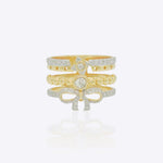 14K gold plated ring with diamond-lined layered bands and a sculpted bow centerpiece.
