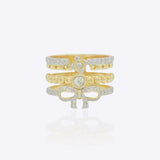 14K gold plated ring with diamond-lined layered bands and a sculpted bow centerpiece.
