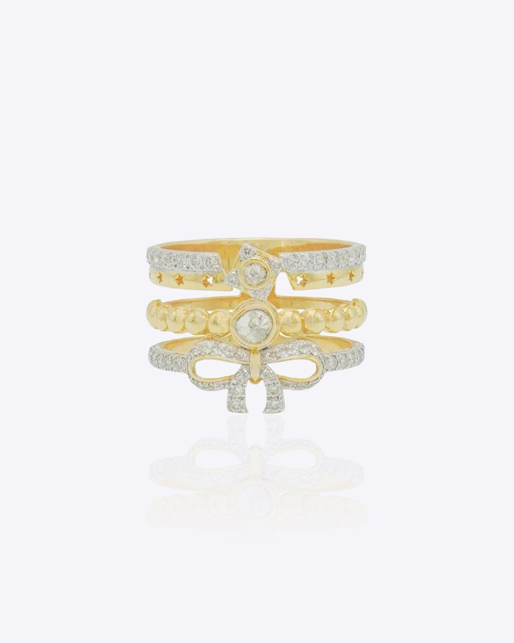 14K gold plated ring with diamond-lined layered bands and a sculpted bow centerpiece.