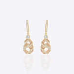 14K gold Nova Hexa earrings with a hexagonal motif, Polki, and diamonds.