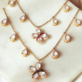 14k gold Papillon Dream Necklace with double-layered chain and Polki droplets.