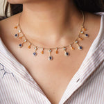 Sapphire and Polki gemstone cascade necklace in 14K gold with warm-toned stones.