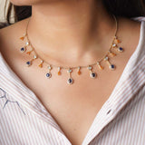 Sapphire and Polki gemstone cascade necklace in 14K gold with warm-toned stones.