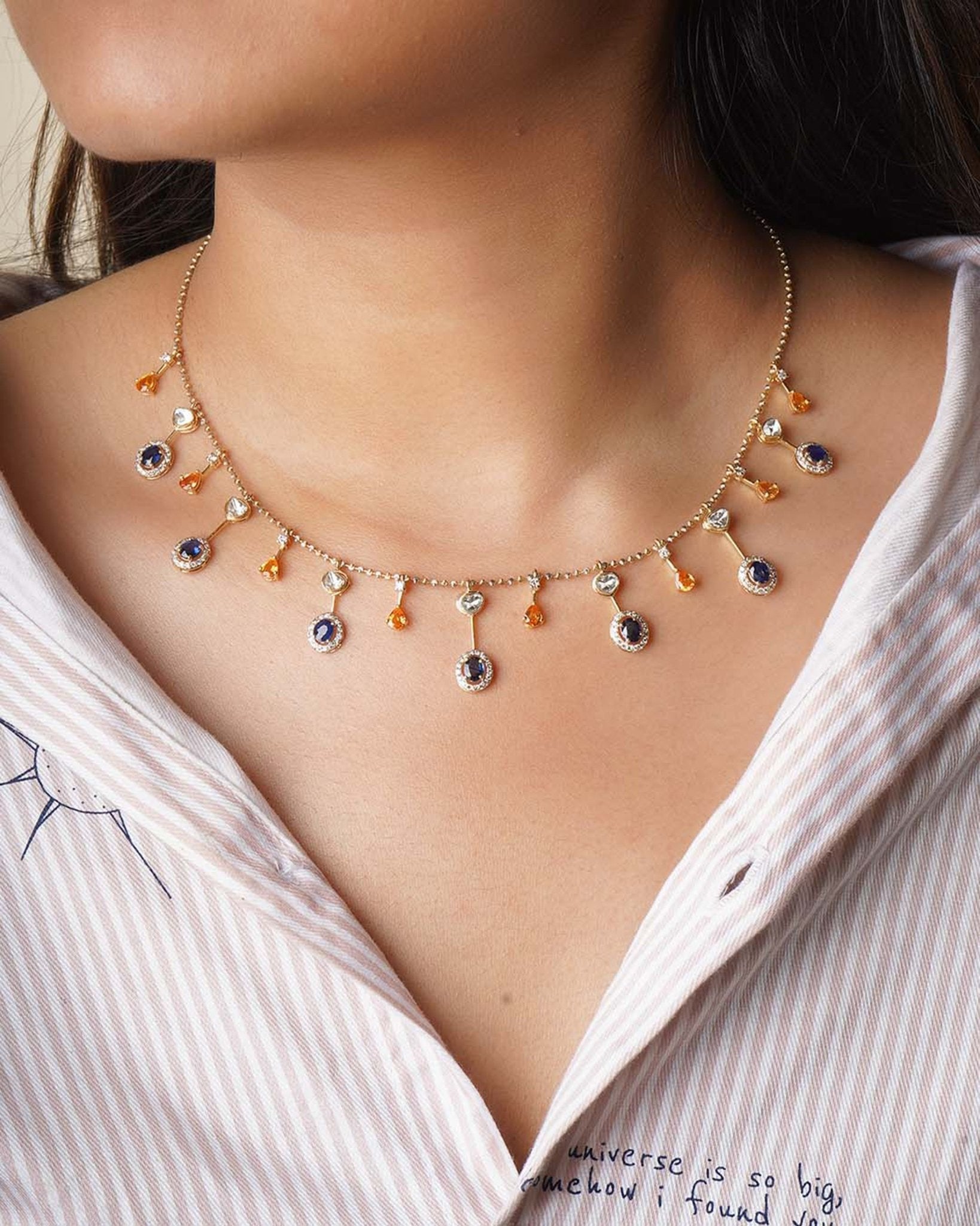 Sapphire and Polki gemstone cascade necklace in 14K gold with warm-toned stones.