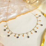 Sapphire and Polki gemstone cascade necklace in 14K gold with warm-toned stones.