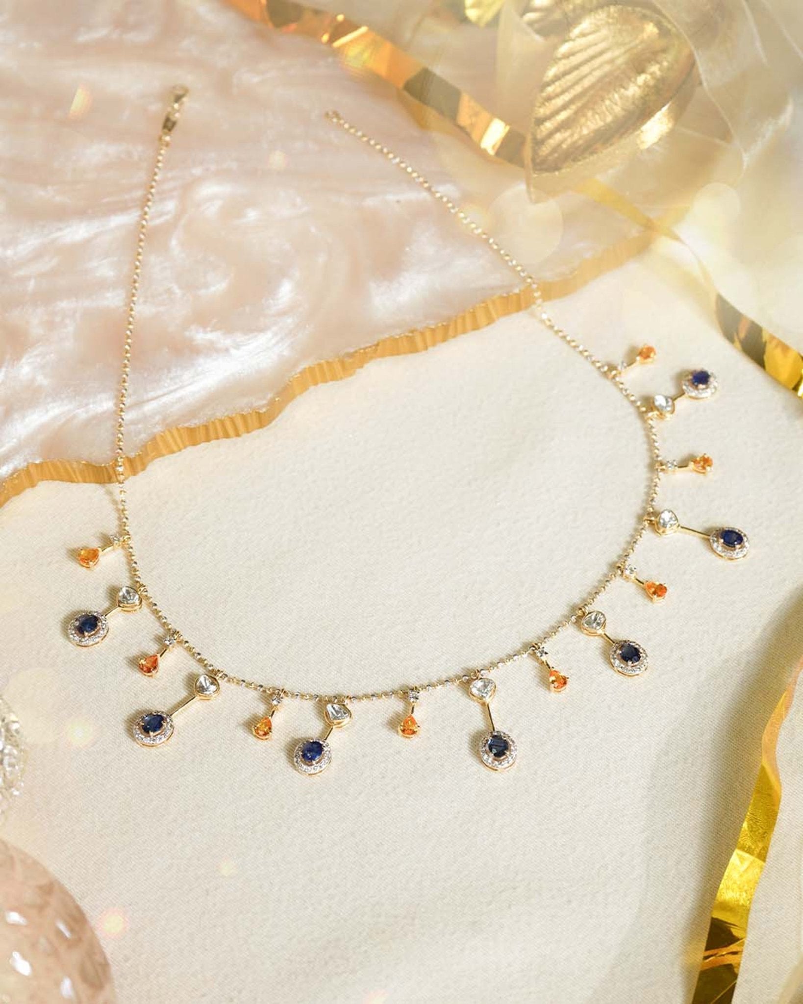 Sapphire and Polki gemstone cascade necklace in 14K gold with warm-toned stones.