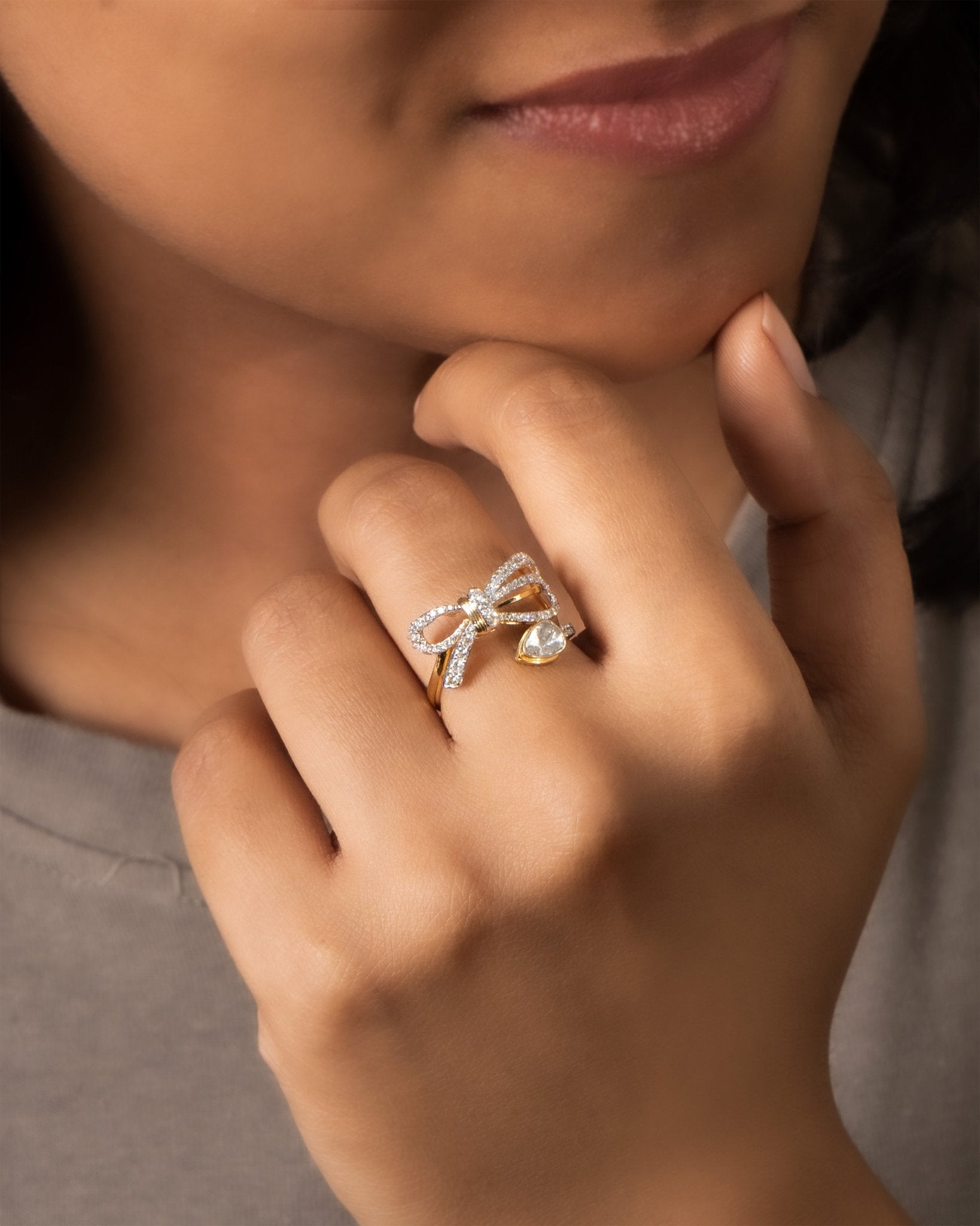 14k gold ring with a sleek, minimalist bow silhouette.