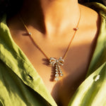 14kt gold necklace with delicate bow design and cascading drops