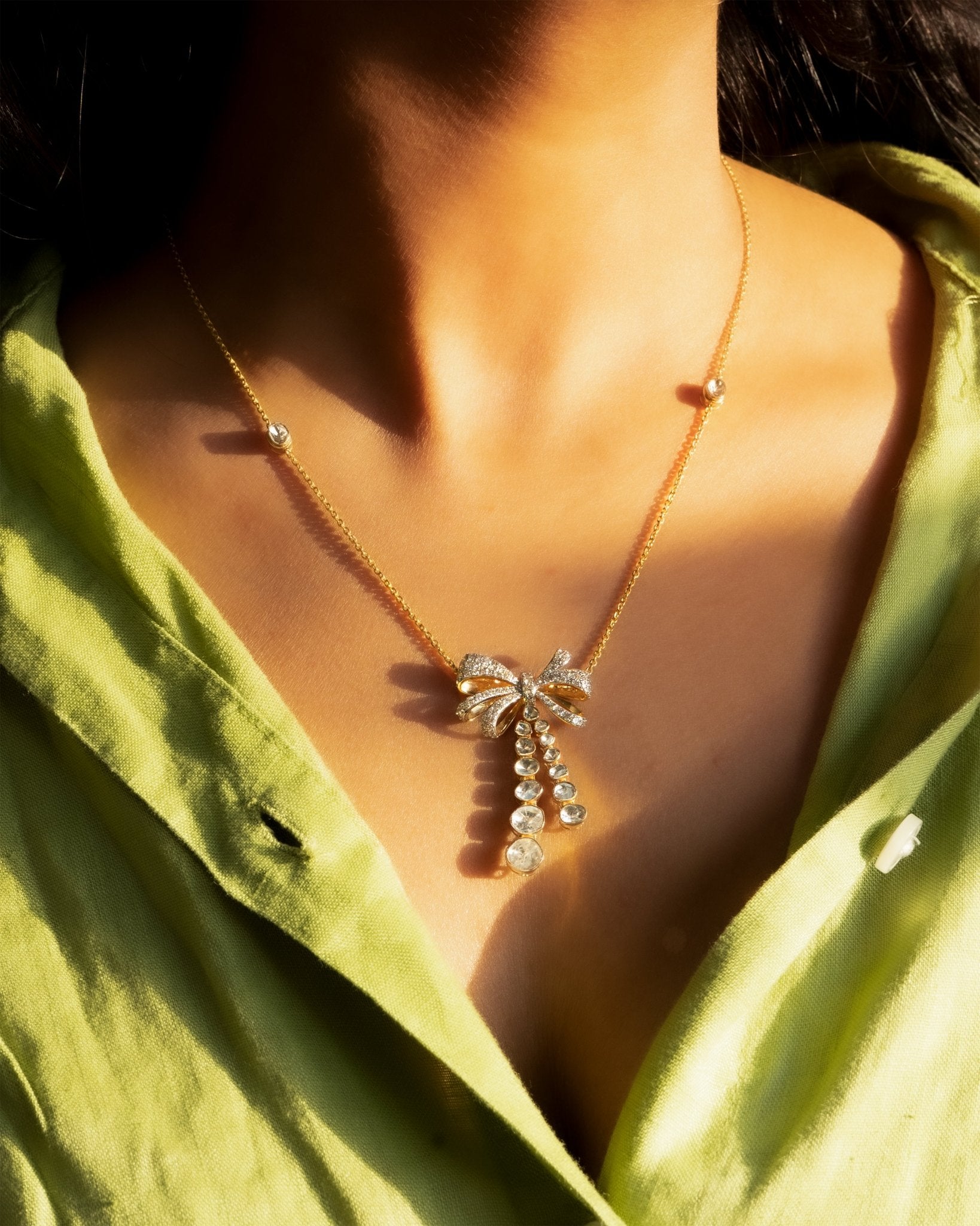 14kt gold necklace with delicate bow design and cascading drops