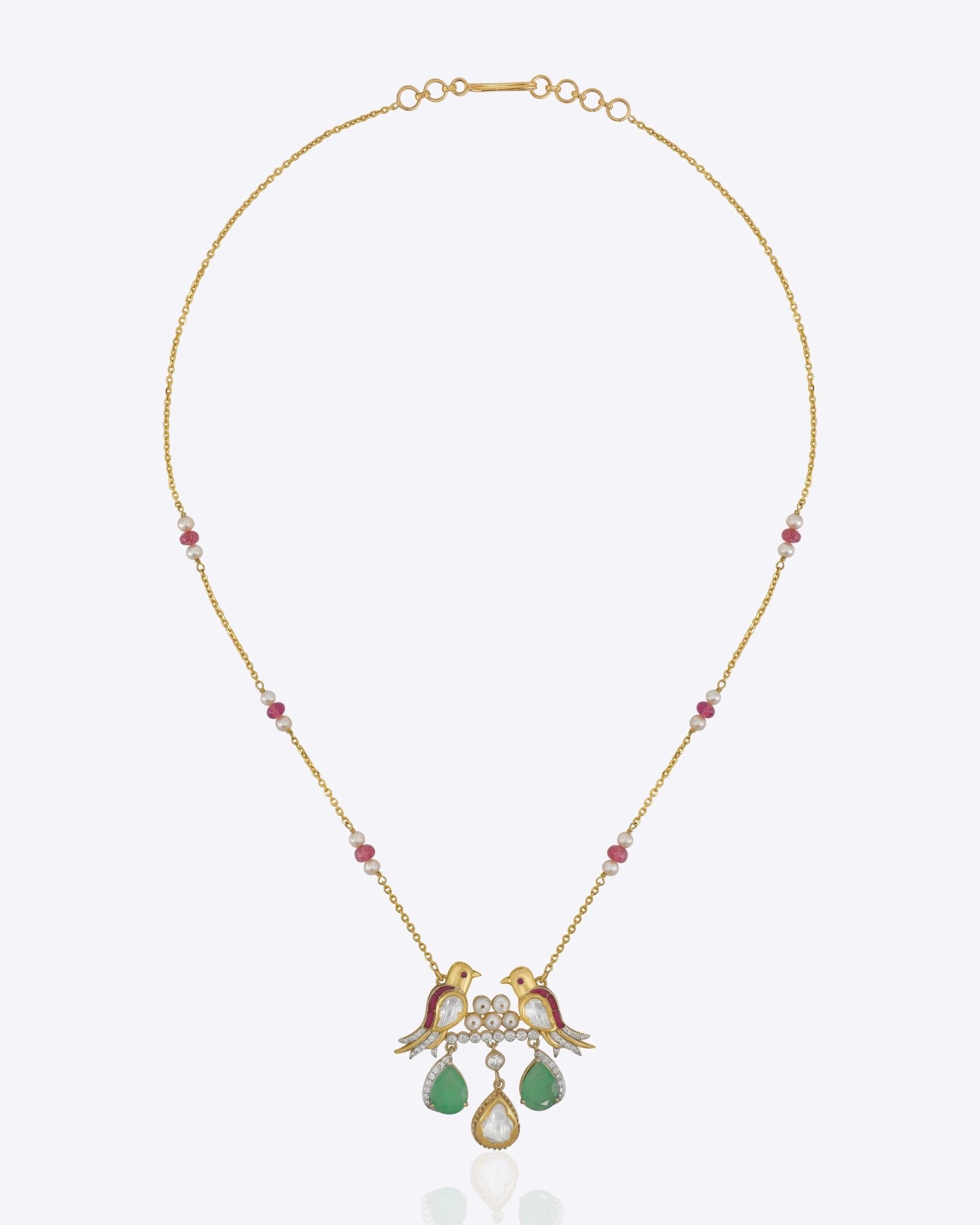 14k gold pendant with sculpted bird motifs and a Polki teardrop