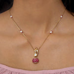 9K gold swan-inspired pendant with Polki diamonds and a pink-hued drop.