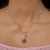 9K gold swan-inspired pendant with Polki diamonds and a pink-hued drop.
