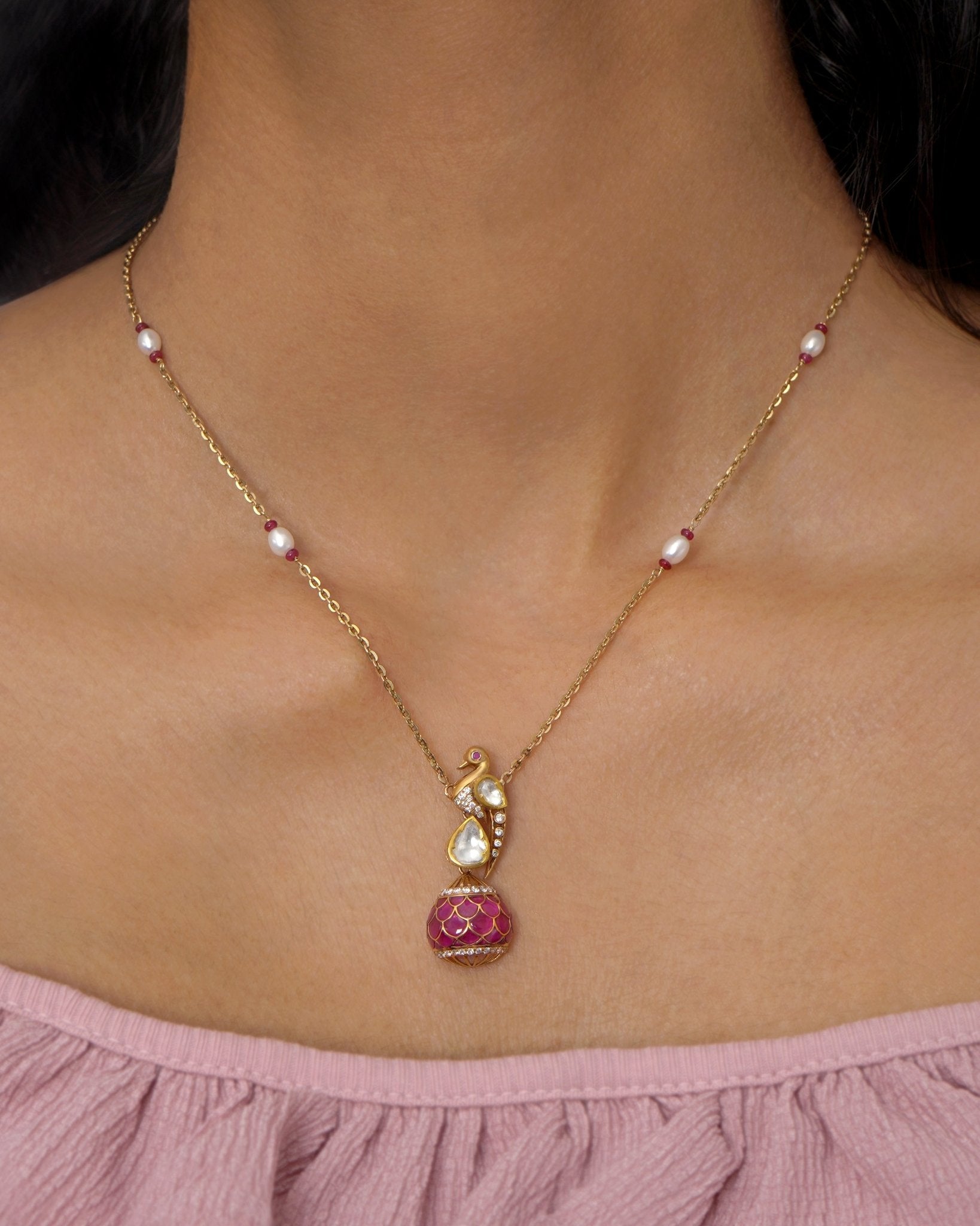 9K gold swan-inspired pendant with Polki diamonds and a pink-hued drop.