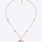 9K gold pendant with a blush petal silhouette and soft pink accents.