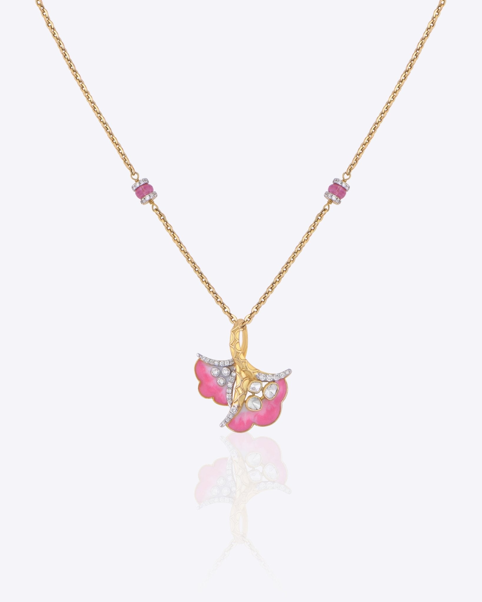 9K gold pendant with a blush petal silhouette and soft pink accents.