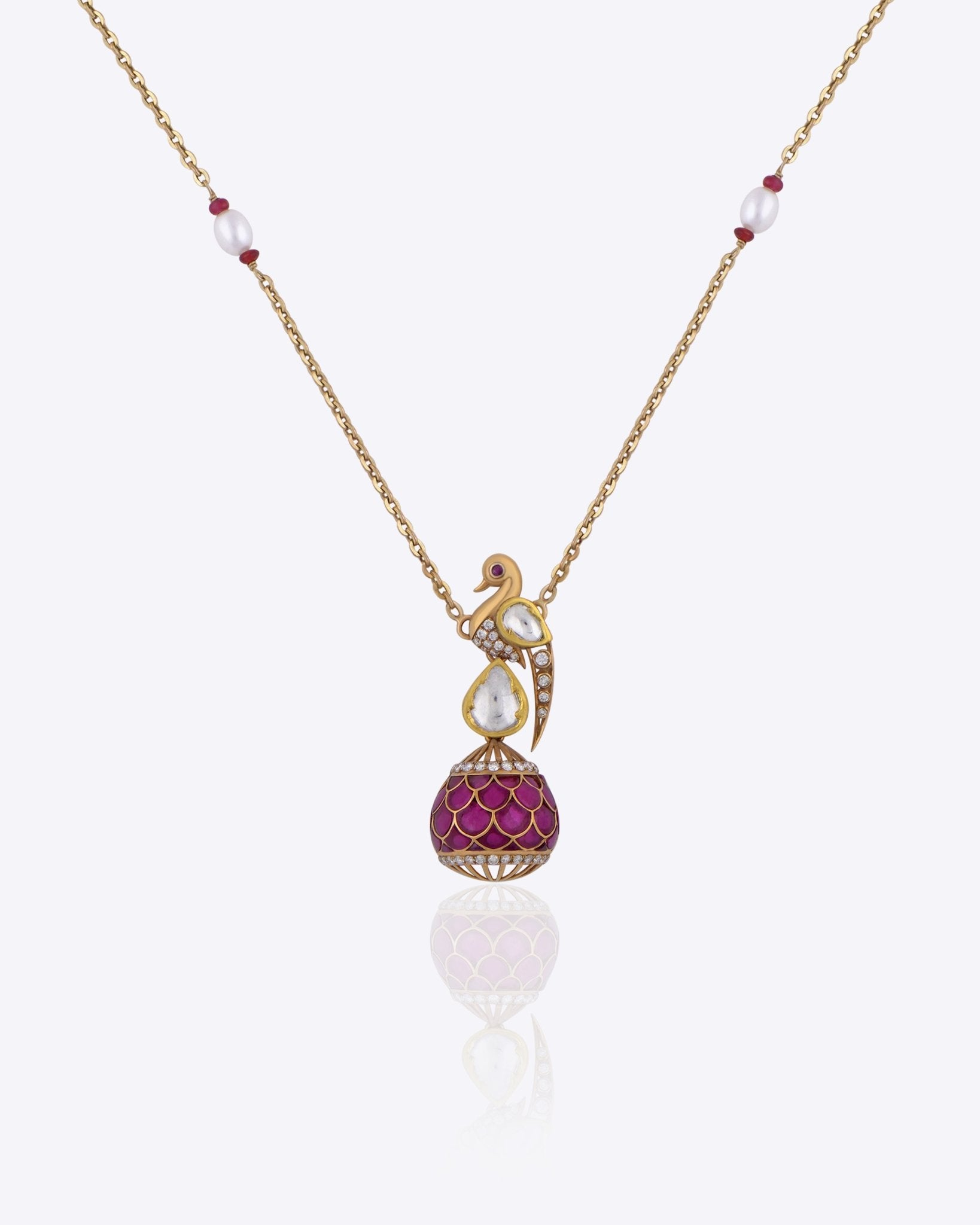 9K gold swan-inspired pendant with Polki diamonds and a pink-hued drop.