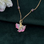 9K gold pendant with a blush petal silhouette and soft pink accents.