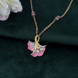 9K gold pendant with a blush petal silhouette and soft pink accents.