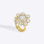 Gold floral ring with uncut diamond petal clusters around an oval center.