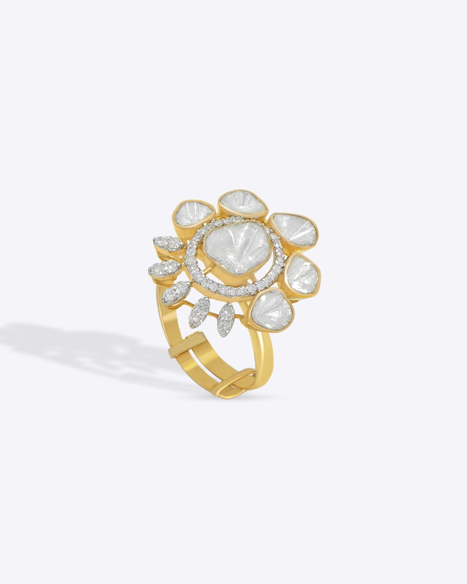 Gold floral ring with uncut diamond petal clusters around an oval center.
