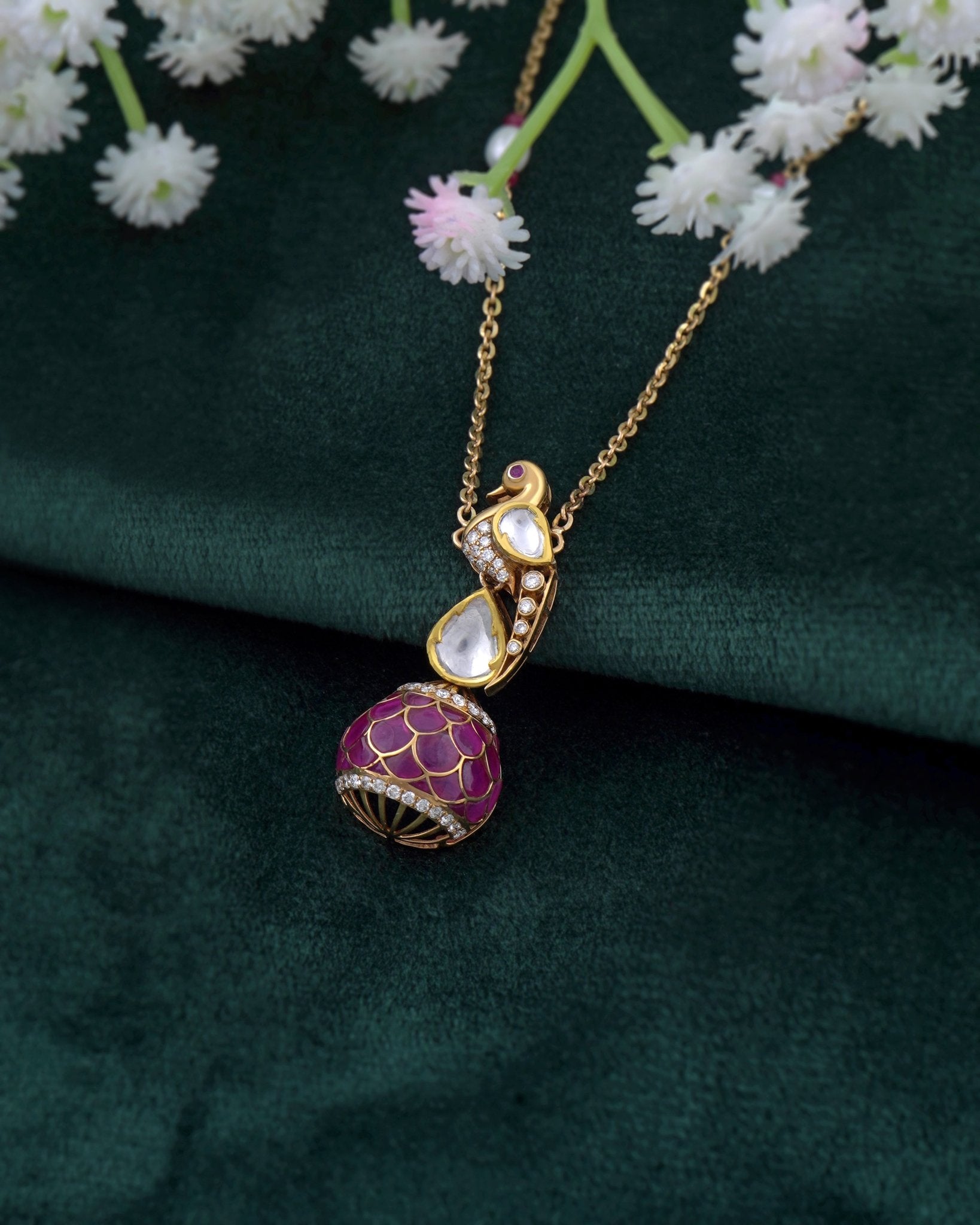 9K gold swan-inspired pendant with Polki diamonds and a pink-hued drop.