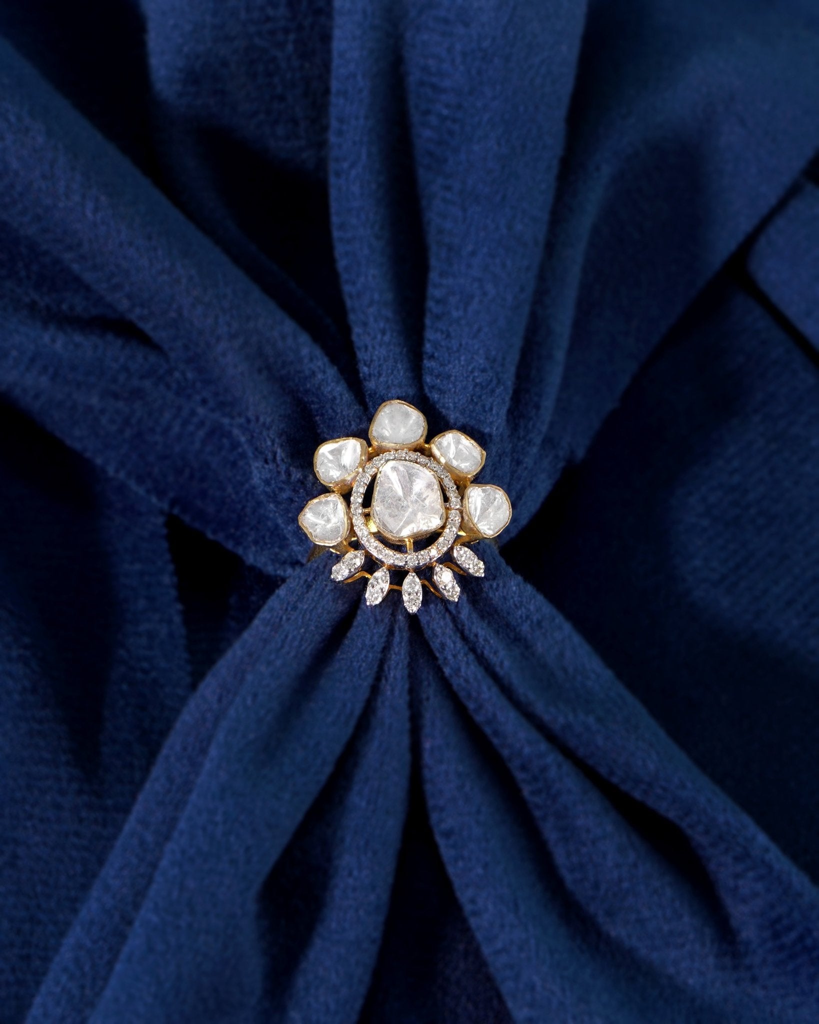 Gold floral ring with uncut diamond petal clusters around an oval center.