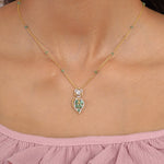 Teal Leaf Pendant in 9K gold with teal gemstone stations and a pear-cut teal drop.