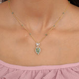 Teal Leaf Pendant in 9K gold with teal gemstone stations and a pear-cut teal drop.