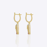 9K gold teardrop earrings with Polki detailing and delicate diamond accents.