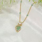 Teal Leaf Pendant in 9K gold with teal gemstone stations and a pear-cut teal drop.