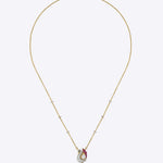 Swan Grace Pendant in 14K gold with a floral motif, uncut diamonds, and pink gemstones.