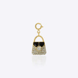 14k gold bag charm with a mix of diamonds and Polki