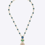 18k gold necklace uniting Polki, diamonds, morganite, and emeralds in a bold design.