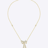 14kt gold necklace with delicate bow design and cascading drops