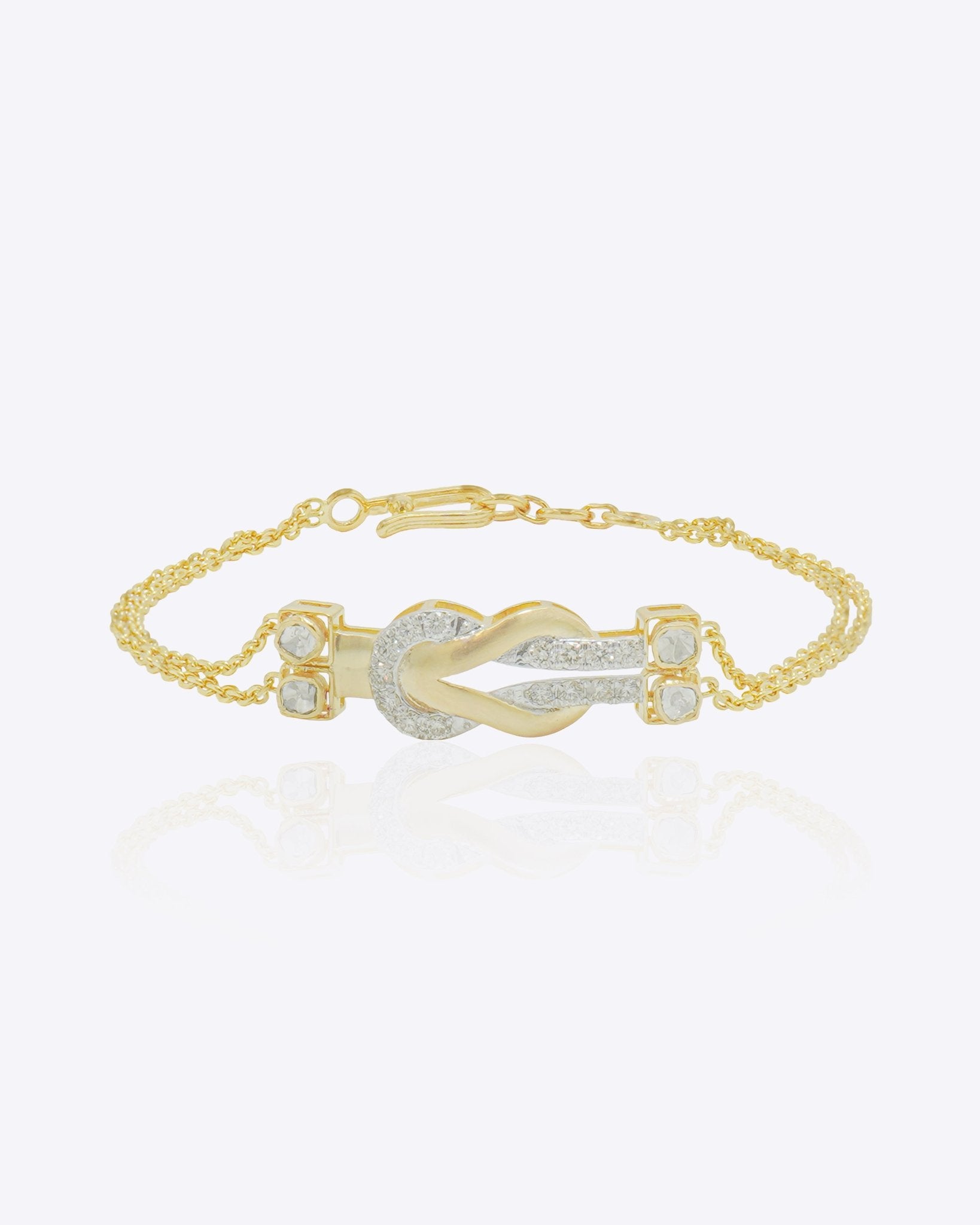 14K gold bracelet with a graceful chain and a knot of Polki diamonds.